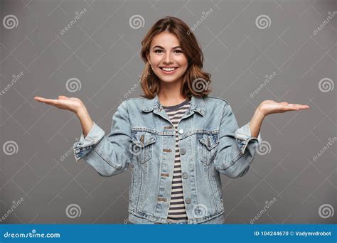 Close Up Portrait Of Attractive Smiling Woman In Casual Wear Showing