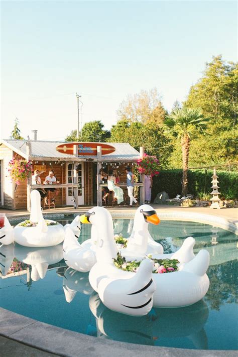 Several Inflatable Ducks Sitting On The Edge Of A Pool