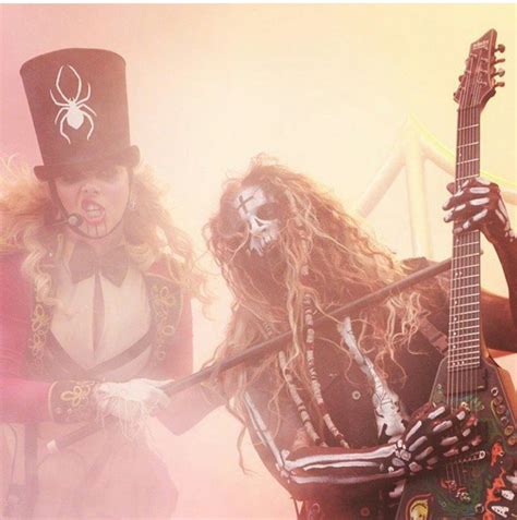 Two People Dressed Up In Costumes Playing Guitars