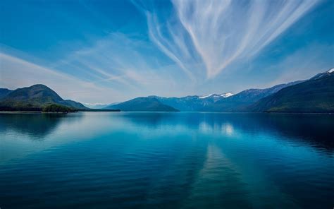 Online Crop Body Of Calm Lake Under Blue Sky During Daytime Water