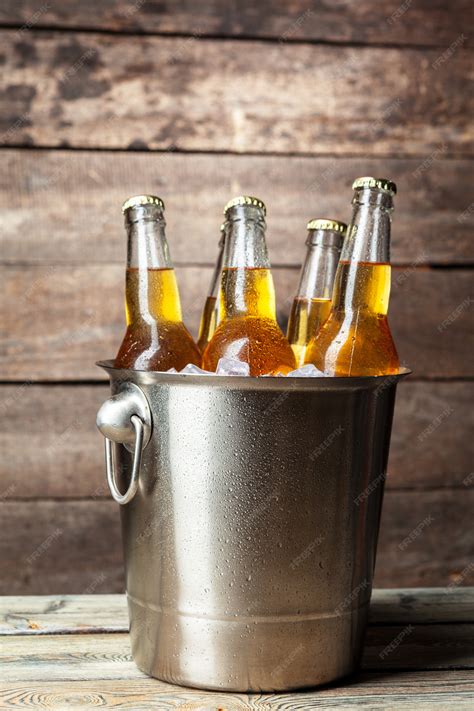 Premium Photo Cold Bottles Of Beer In The Bucket On Wooden