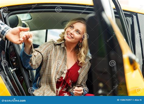 Photo Of Man Giving Hand To Blonde Woman Sitting In Back Seat Of Taxi Stock Image Image Of