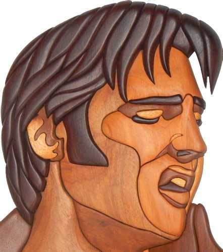 A Wood Carving Of A Man With His Hair Pulled Back And Eyes Closed