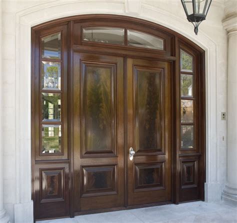 The heavier wooden grills really highlight the window panes, giving this entrance a more stately look. front door | Mahogany entry doors, House front door design ...