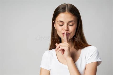 Beautiful Woman With Closed Eyes Holds A Finger Near Her Lips On A