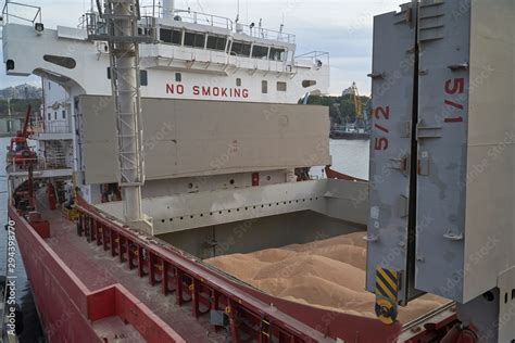 Grain Loading In Hold Of Bulk Carrier Ship With Elevator Crane Closeup