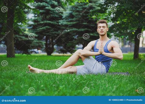 Young Man Practicing Yogaoutdoors Stock Photo Image Of Active Green