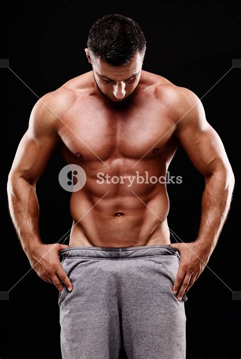 Handsome Muscular Man Shirtless Wearing White Pants Over Black Background Royalty Free Stock