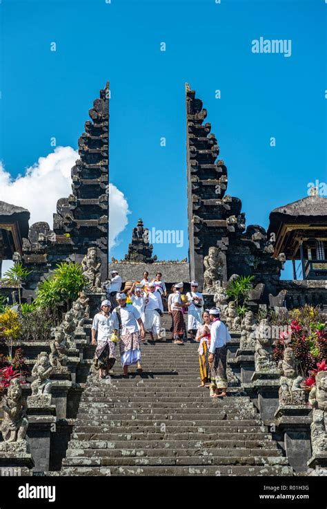 Balinese Believers In Traditional Clothing Go Down Stairs Split Gate