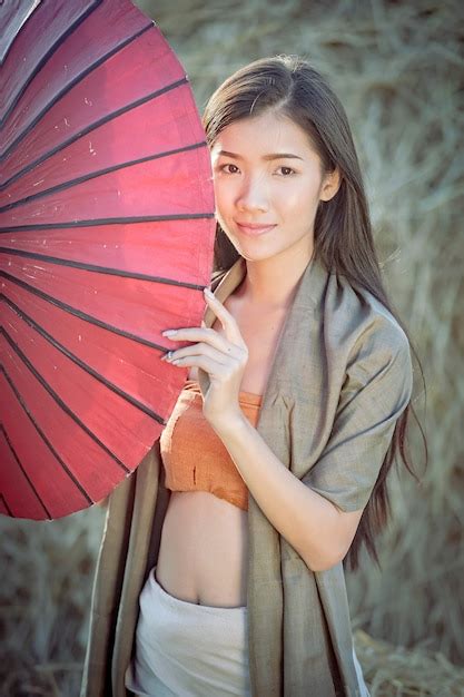 premium photo beautiful thai girl in traditional dress costume red umbrella