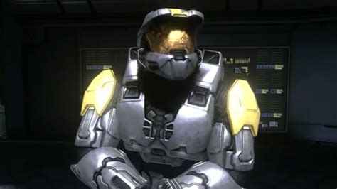 An Image Of A Man In A Sci Fi Suit Sitting Down With His Hands On His