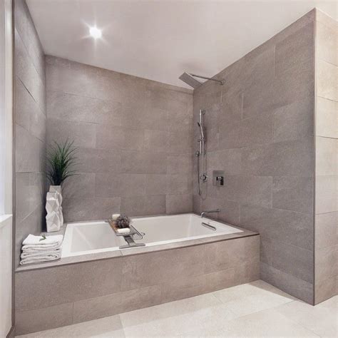 It offers soothing comfort, durability, and excellent a versatile design makes installation pretty straightforward. gray wall indent gray shower tiles soaking tub with shower ...