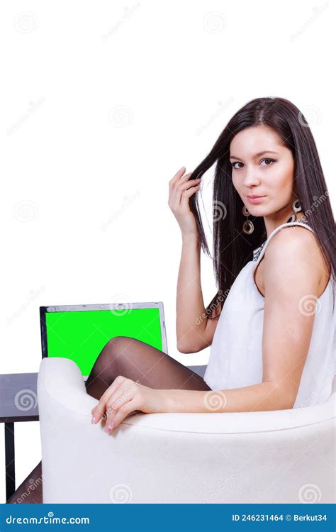 A Slender Girl Sits In A Chair In Front Of A Laptop And Touches Her