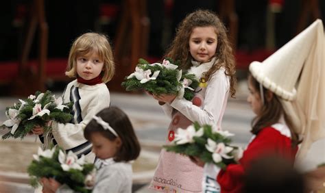 Children Carry Flowers In Procession As They Leave Christmas Eve Mass
