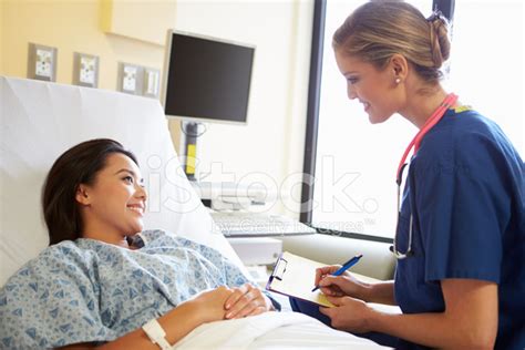 Nurse Talking To Female Patient On Ward Stock Photo Royalty Free