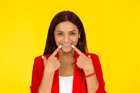 Woman Showing Perfect Smile Pointing With Hand Fingers Stock Image