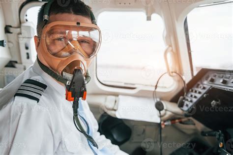 In Oxygen Mask Pilot On The Work In The Passenger Airplane Preparing