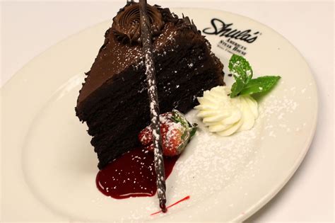 Chocolate Seven Layer Cake Served With A Raspberry Coulis Whipped