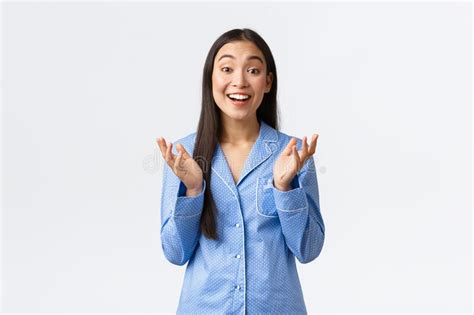 Happy Beautiful Asian Girl In Blue Pajamas Raising Hands And Clapping