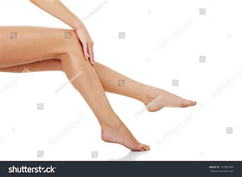 Naked Long Legs Of Sitting Woman Her Hand Is Touching Skin On Smooth
