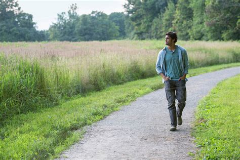 A Young Man Walking Down A Path With His Hands In His Pockets Stock 10d