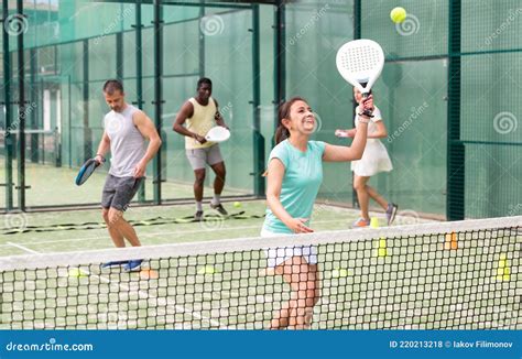 Sporty Woman And Other Athletes Training On Tennis Court Stock Photo