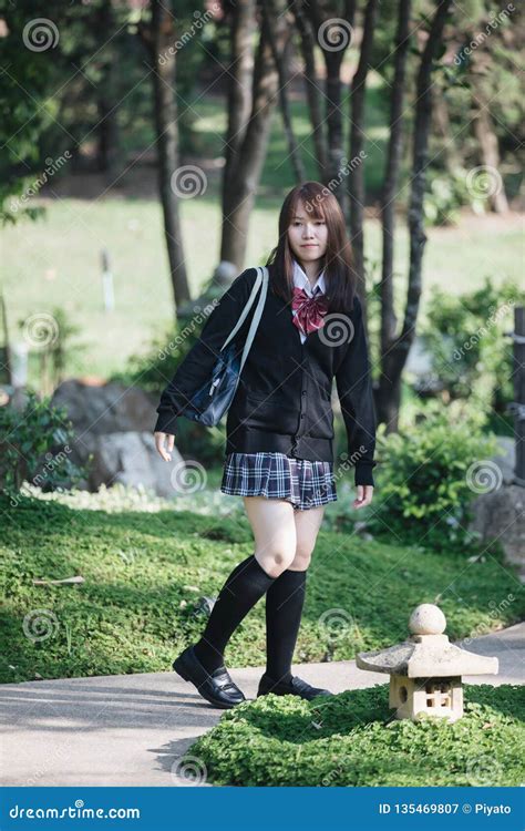 Portrait Of Asian Japanese School Girl Costume Looking At Park Outdoor Film Vintage Style Stock