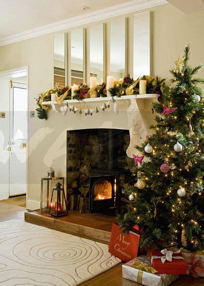 Image Christmas Tree Beside Fireplace With Lighted Fire Below