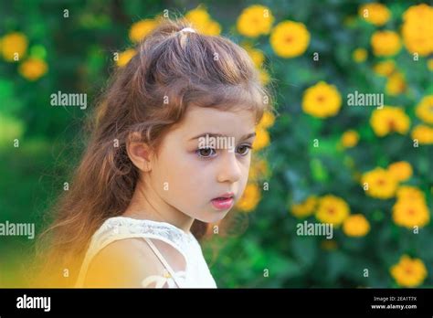 Portrait Of Sad Cute Little Girl Looking Sad And Afraid At The Summer