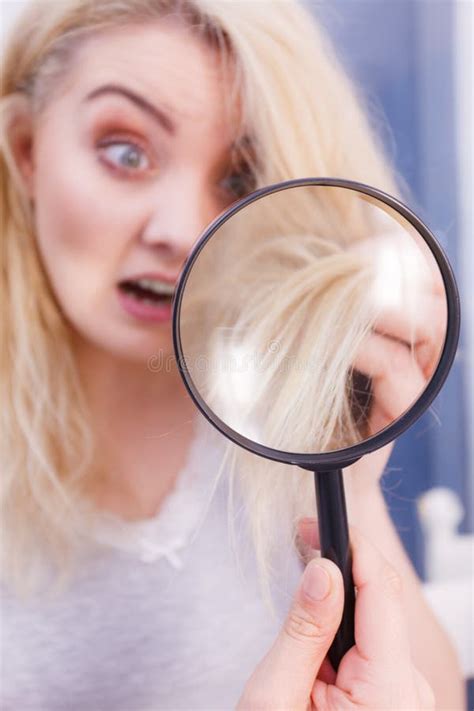 Woman Looking At Hair Ends Through Magnifying Glass Stock Photo Image