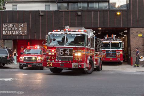 Firefighters Trucks Leaving Their Fire Station Stock Photo Download