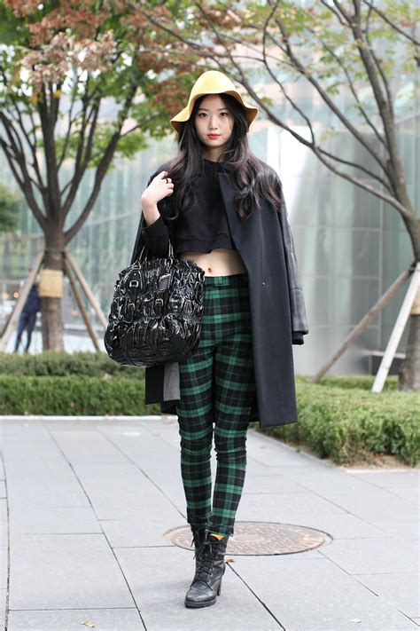 It Takes A Lot To Make Us Covet A Bucket Hat Her Slim Cut Tartan Trousers And Sleek Black Coat