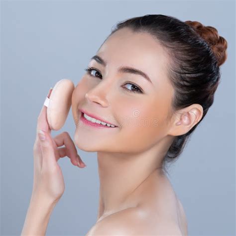 Glamorous Beautiful Female Model Applying Powder Puff For Facial Makeup