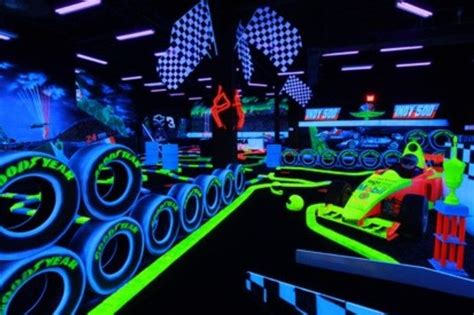 An Indoor Game Room With Neon Colored Lights