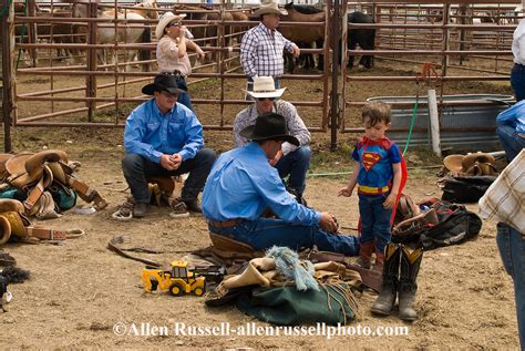 Saddle Bronc Rider Behind Rodeo Chutes With Son Who Came