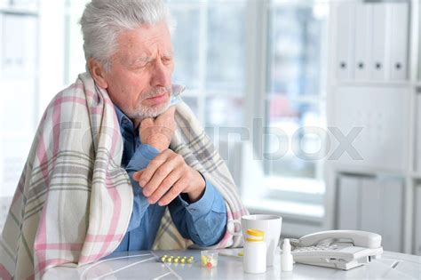sick elderly man with pills stock image colourbox