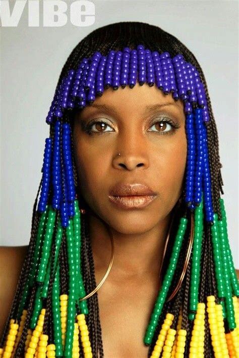 Erykah Badu Decked Out In Blue Green And Yellow Beads And Braids
