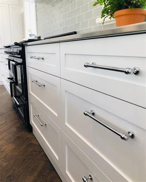 I was adamant that the handles be even and perfect. 8 White Kitchen Cabinets With Inexpensive Chrome Hardware ...