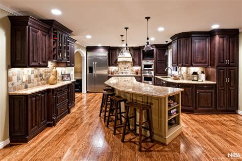Get tips for cutting costs at every step, from demolishing your kitchen cabinets to installing your new backsplash. Large Kitchen Remodel with Dark Cabinets and Cherry Floors ...