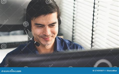 Young Competent Asian Male Call Center Agent Working In The Office