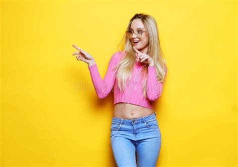 Woman Surprise Showing Product Beautiful Girl With Long Blond Hair Pointing To The Side Stock