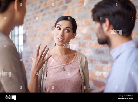 Explaining her brilliant business ideas. three young colleagues in