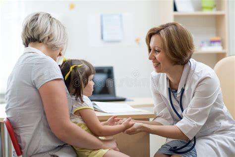 Little Girl With Her Mother At A Doctor On Consultation Stock Photo