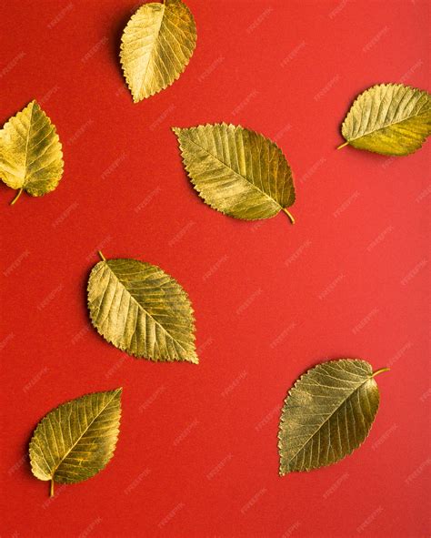 Premium Photo Golden Autumn Leaves On A Red Background Autumn Concept