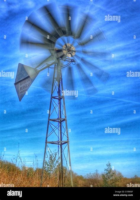Windmill With Moving Rotors Against A Strong Blue Sky Stock Photo Alamy