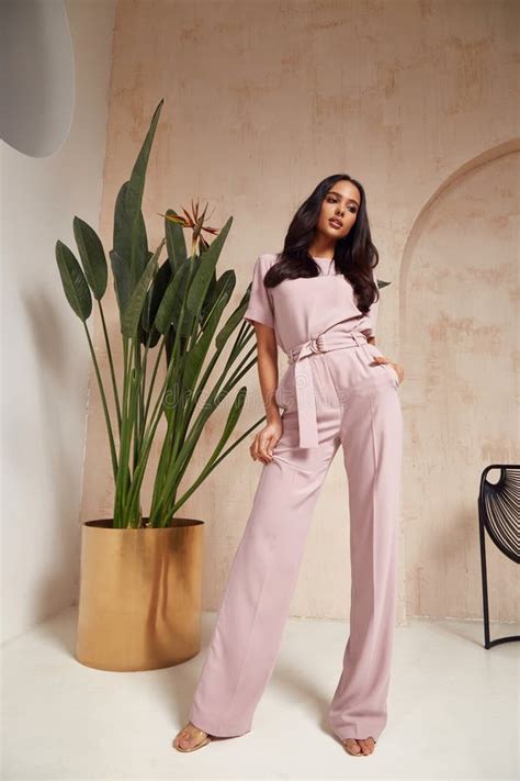 Beautiful Brunette Woman Tanned Skin Face Cosmetic Makeup Wear Pink Suit Pants For Date Walk