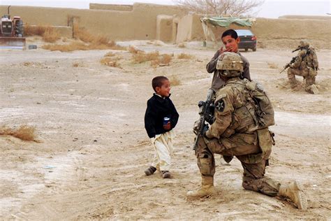 Us Soldiers Provide Security And Interact With Local Afghan Children