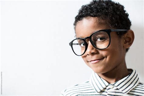 Portrait Of A Smiling Little Boy Wearing A Rimmed Glasses By Stocksy