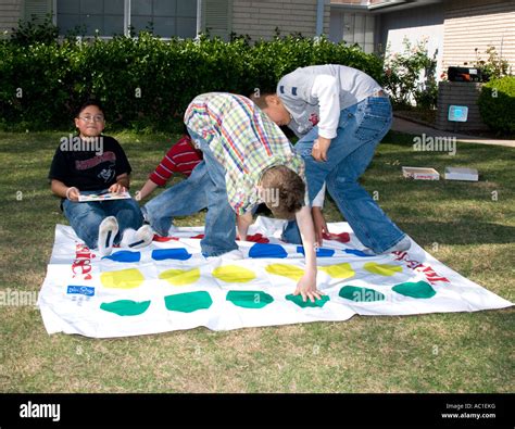 Boys Playing Twister Game On Lawn Oklahoma City Oklahoma Usa Stock