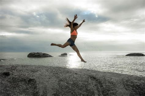 Woman Jumping On A Rock At Sunset On Bakovern Beach Cape Town Stock Photo Image Of Bakovern